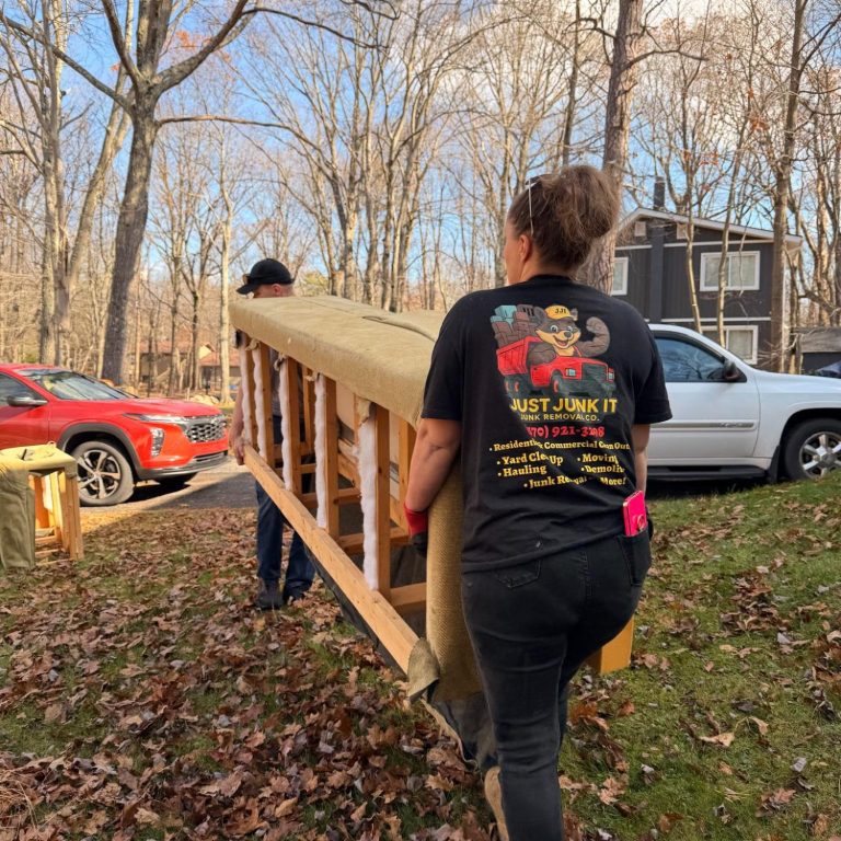 Team Moving Furniture Just Junk It team safely removing and moving furniture during a junk removal project